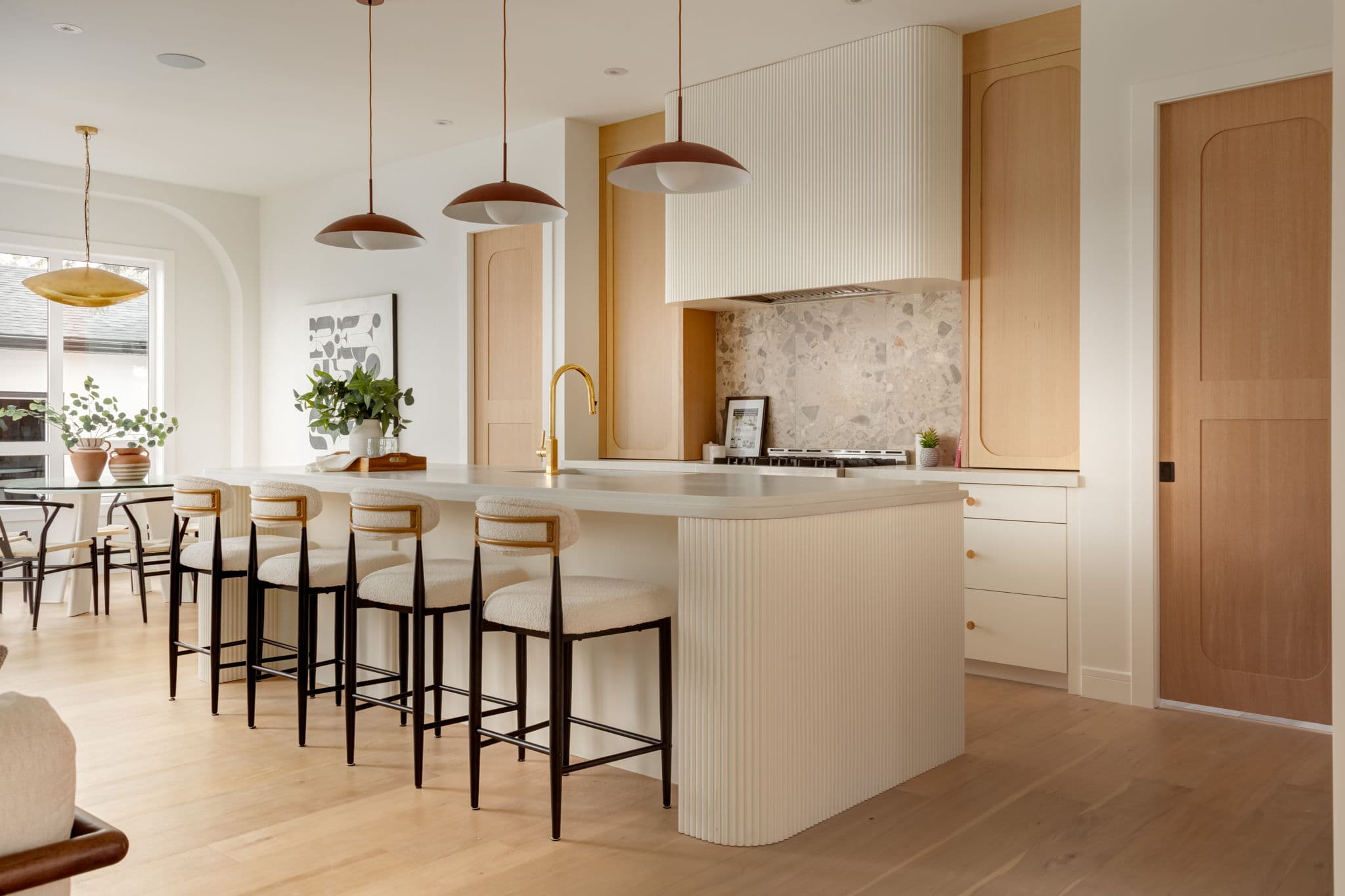 Kitchen island and dining area in the Bowness project by Platinum Build Homes in Bowness, Calgary.