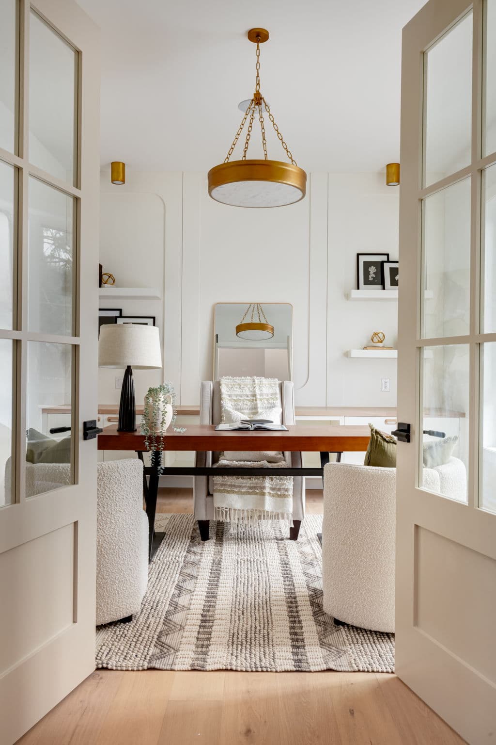 Office viewed through double doors in the Bowness project by Platinum Build Homes in Bowness, Calgary.