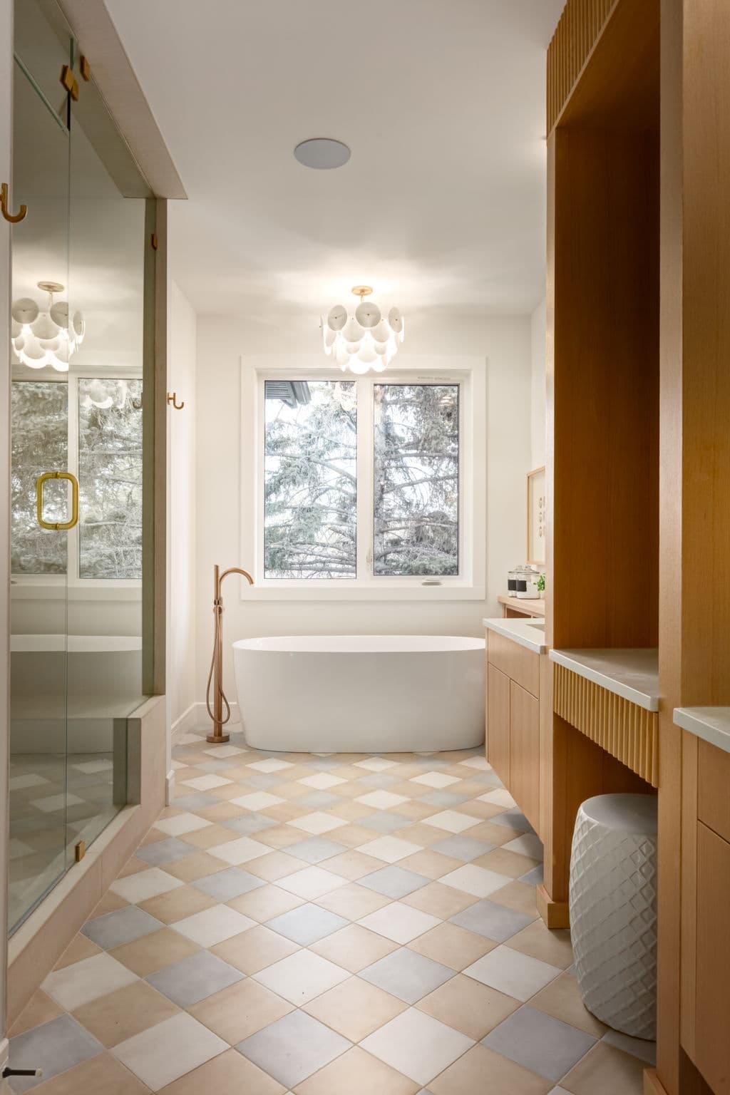 Primary bathroom with freestanding tub in the Bowness project by Platinum Build Homes in Bowness, Calgary.