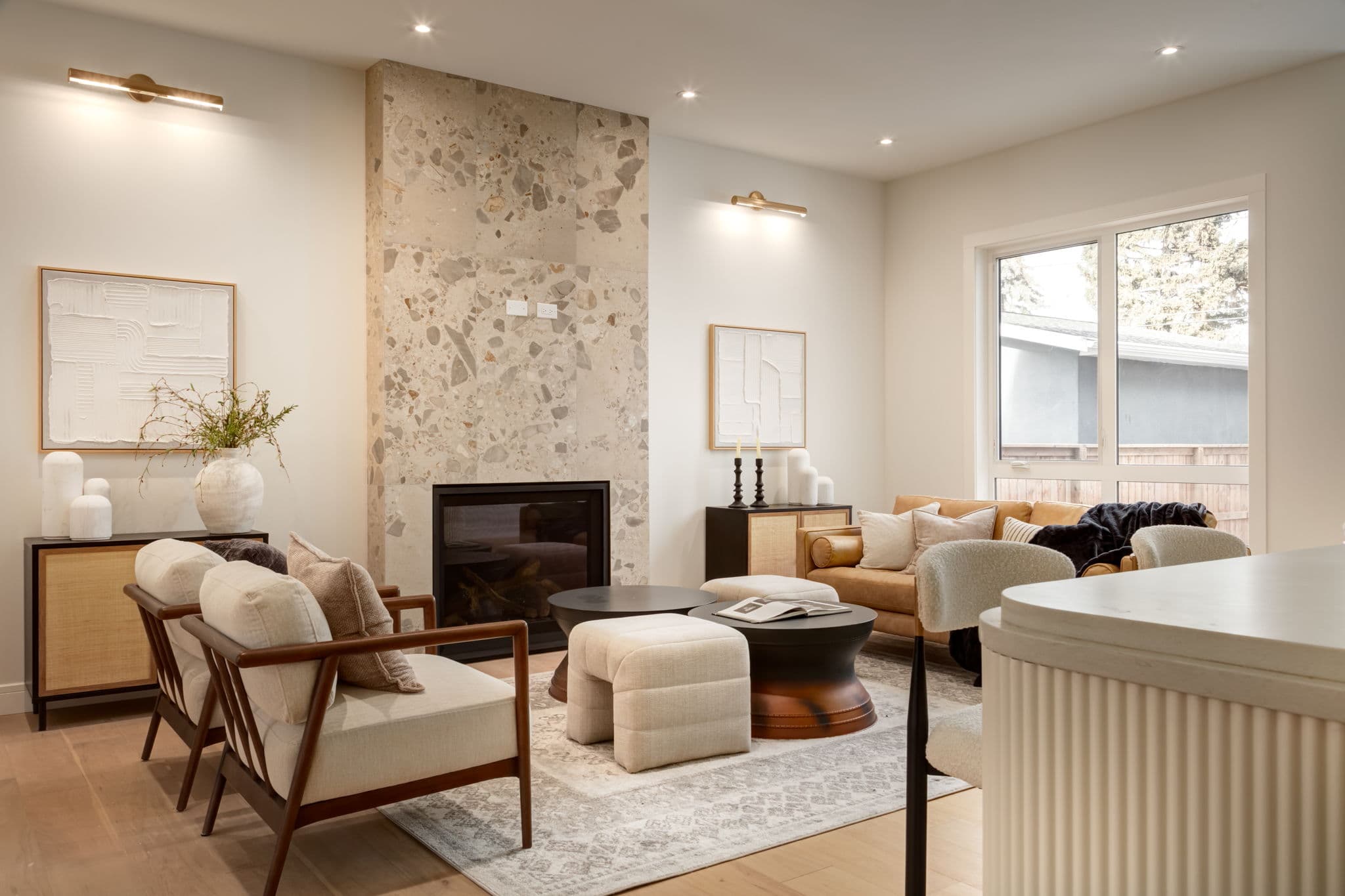 Living room fireplace and seating area in the Bowness project by Platinum Build Homes in Bowness, Calgary.