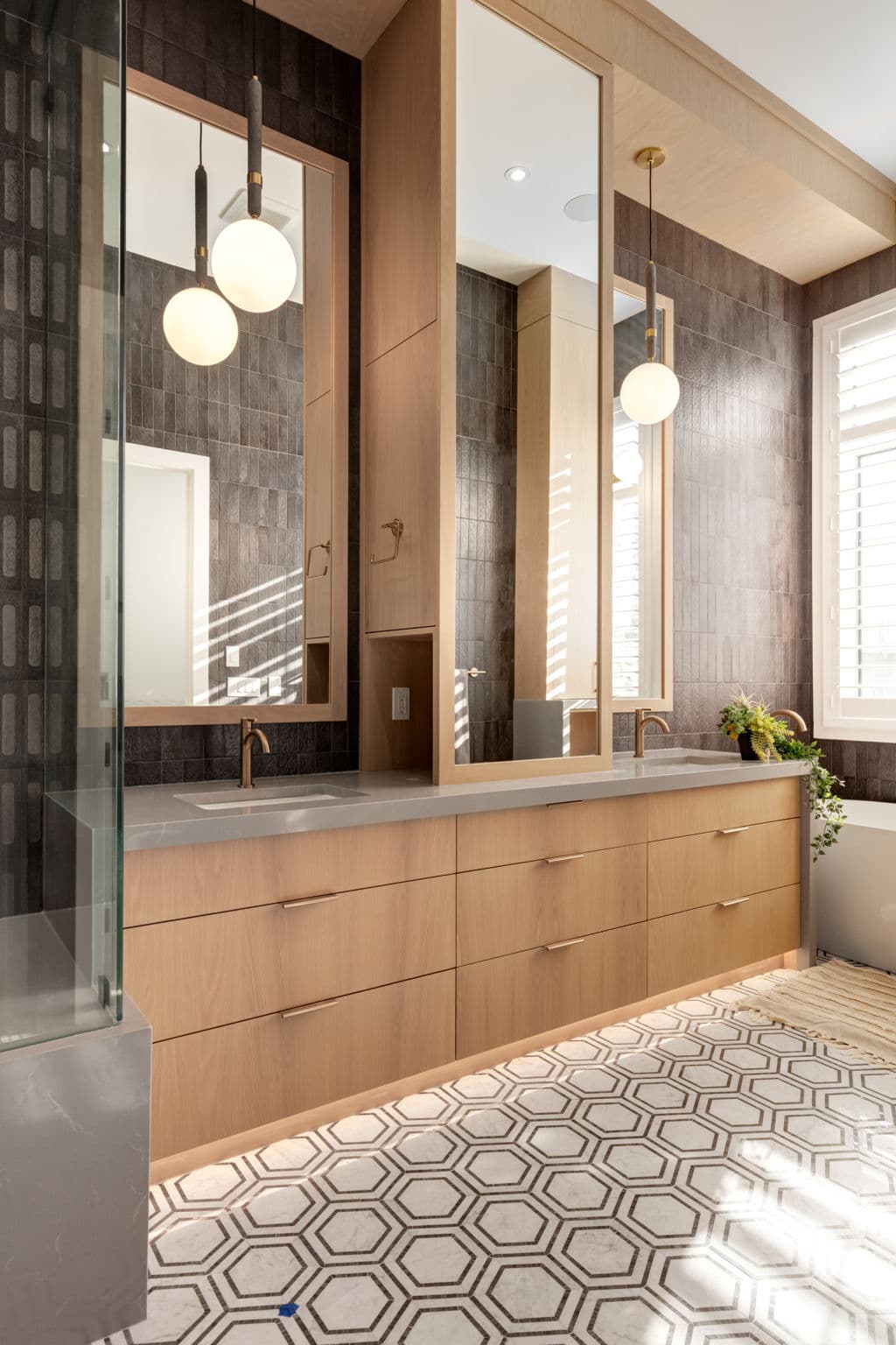 Primary ensuite vanity and patterned floor in the Lakeview 1 project by Platinum Build Homes in Lakeview, Calgary.