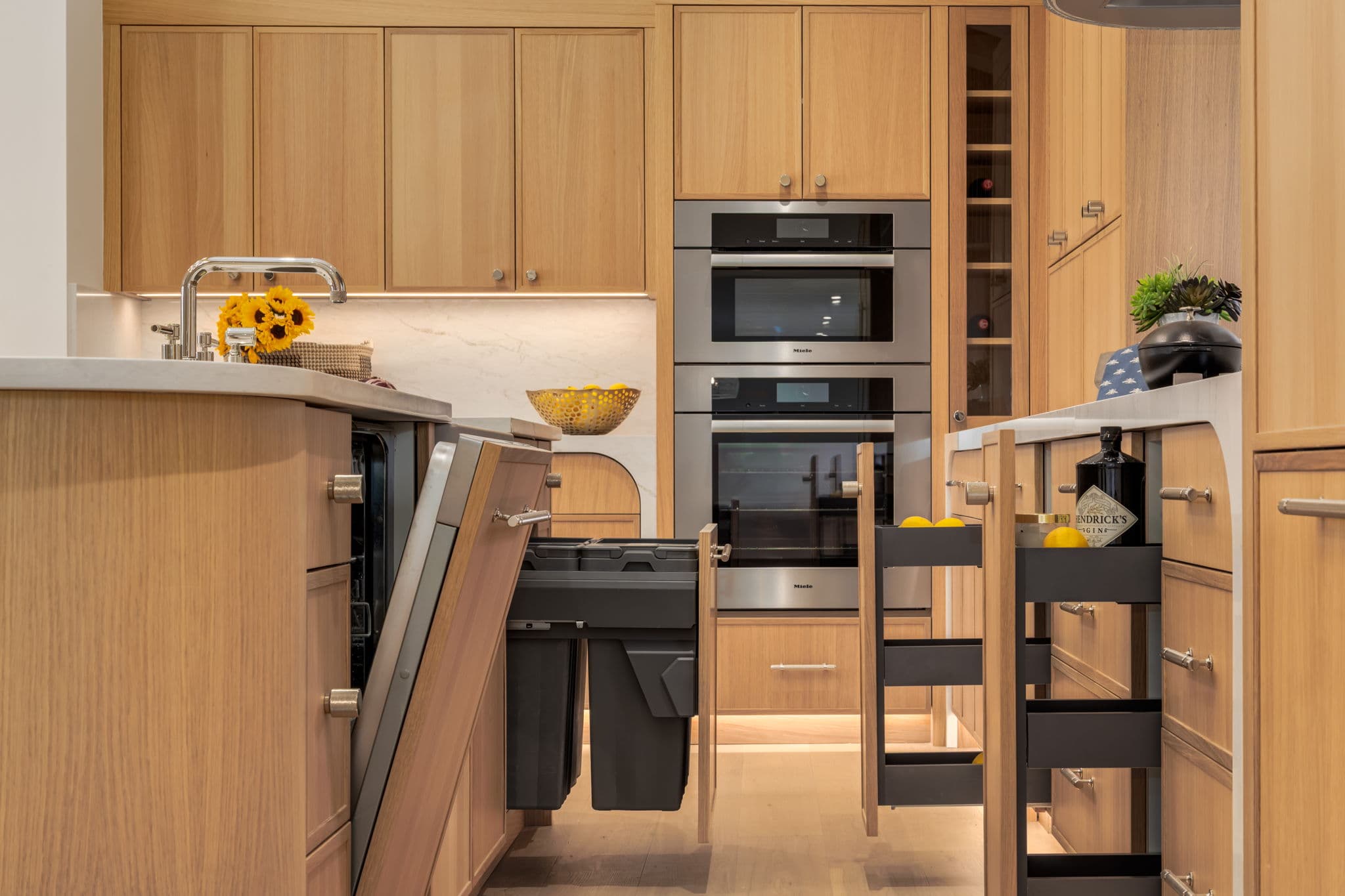 Integrated kitchen pullouts and waste storage in the Varal Road renovation by Platinum Build Homes in Varsity, Calgary.