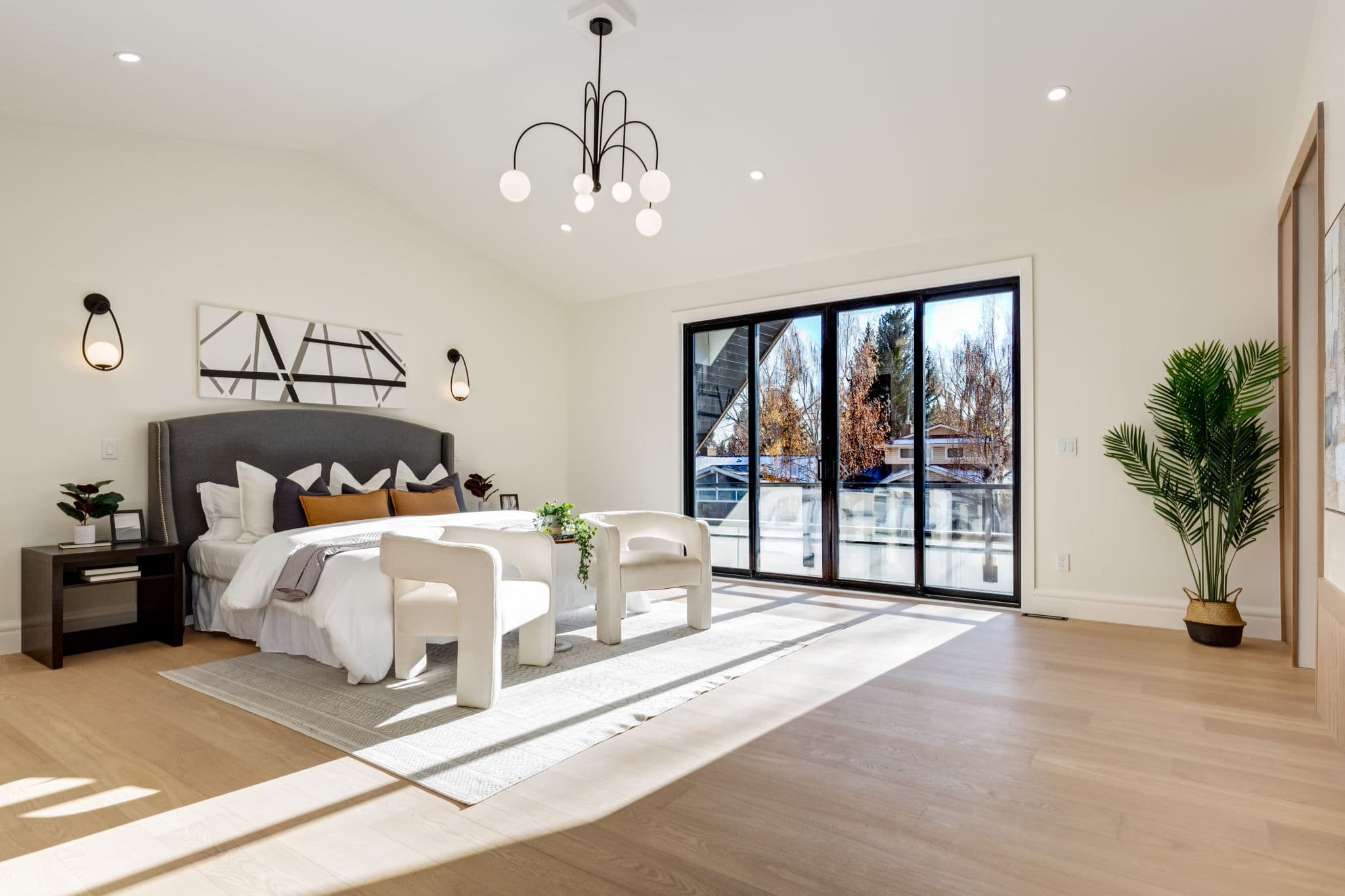 Bedroom with sliding glass doors in the Varsity 1 project by Platinum Build Homes in Varsity, Calgary.