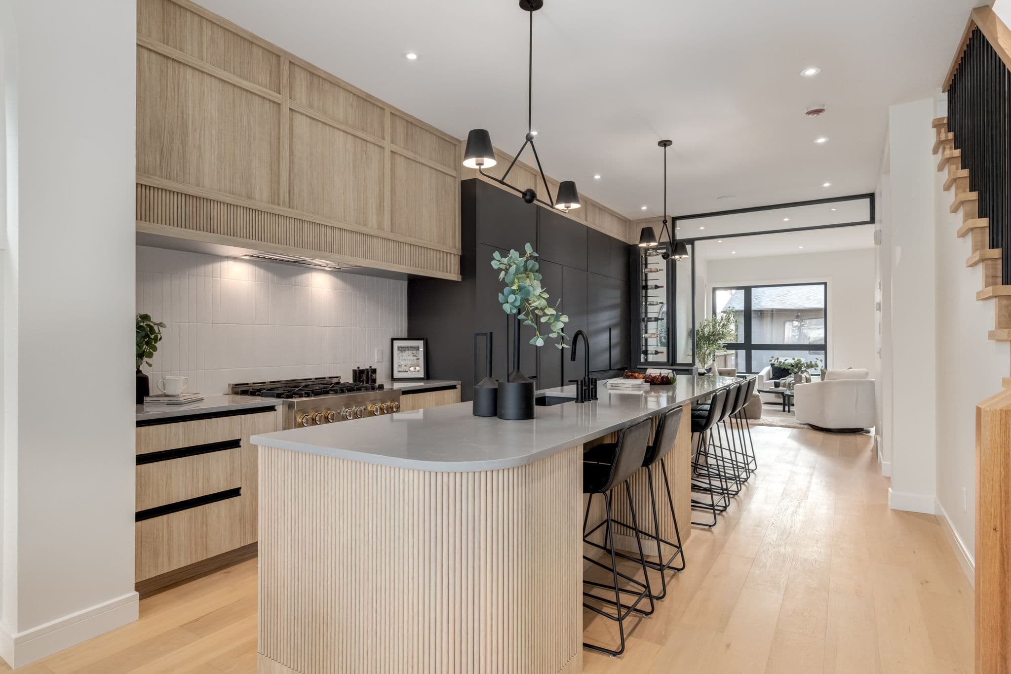 Kitchen island and dining area in the Windsor Park project by Platinum Build Homes in Windsor Park, Calgary.