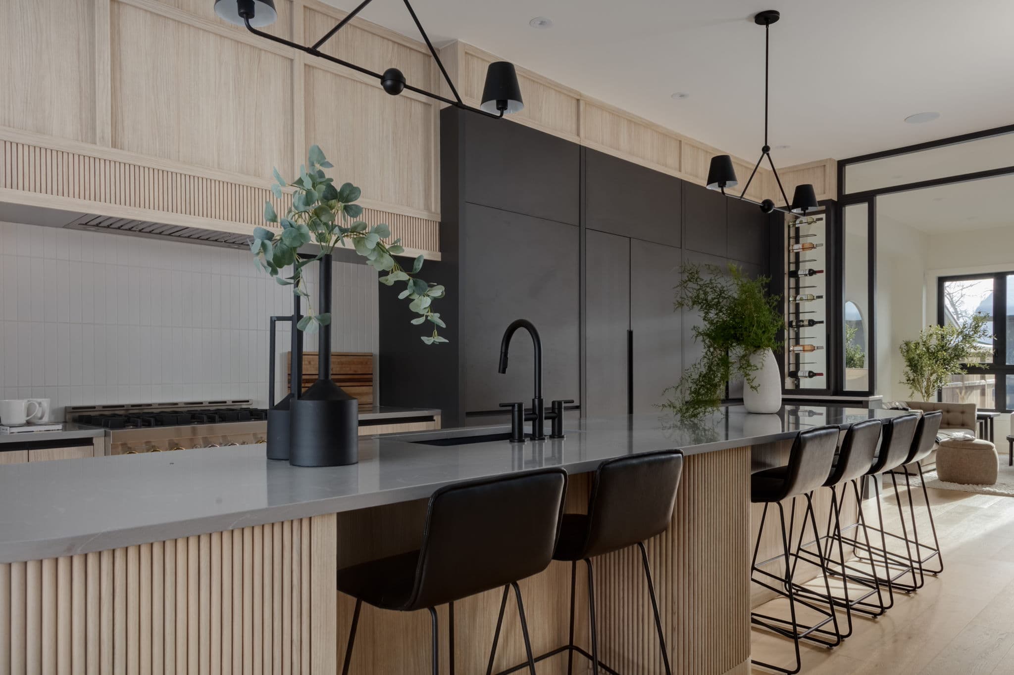 Kitchen island and charcoal cabinetry in the Windsor Park project by Platinum Build Homes in Windsor Park, Calgary.